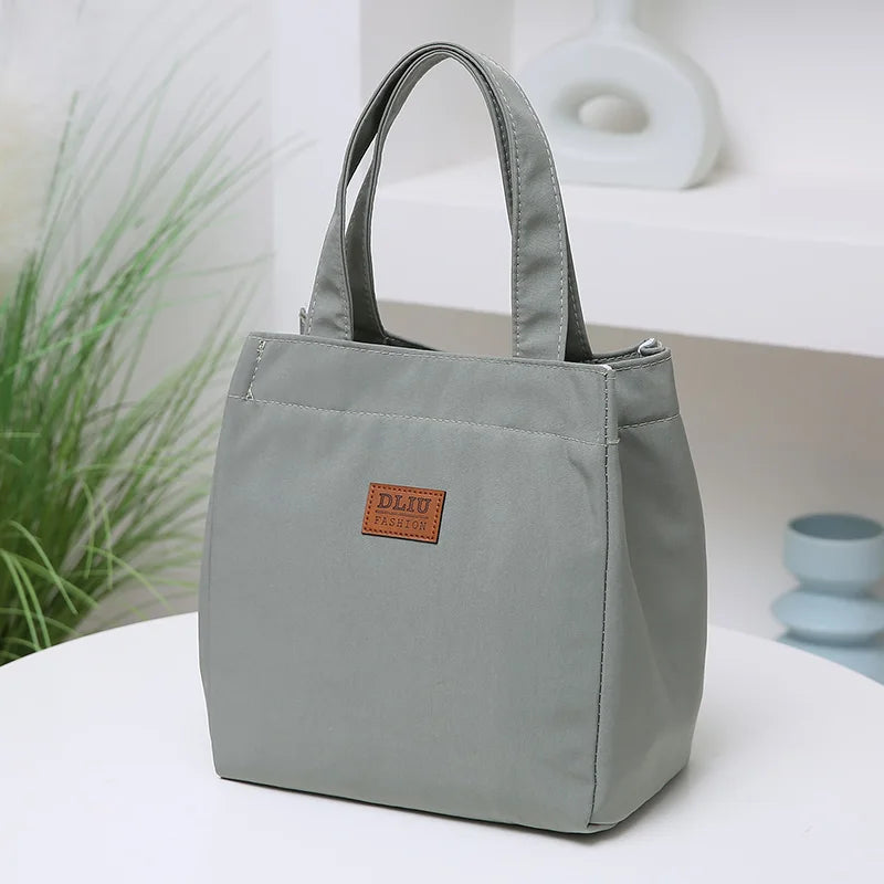 Large insulated lunch bag by Everyday Auraa with aluminum foil thermal lining and top handle for work and travel food storage.