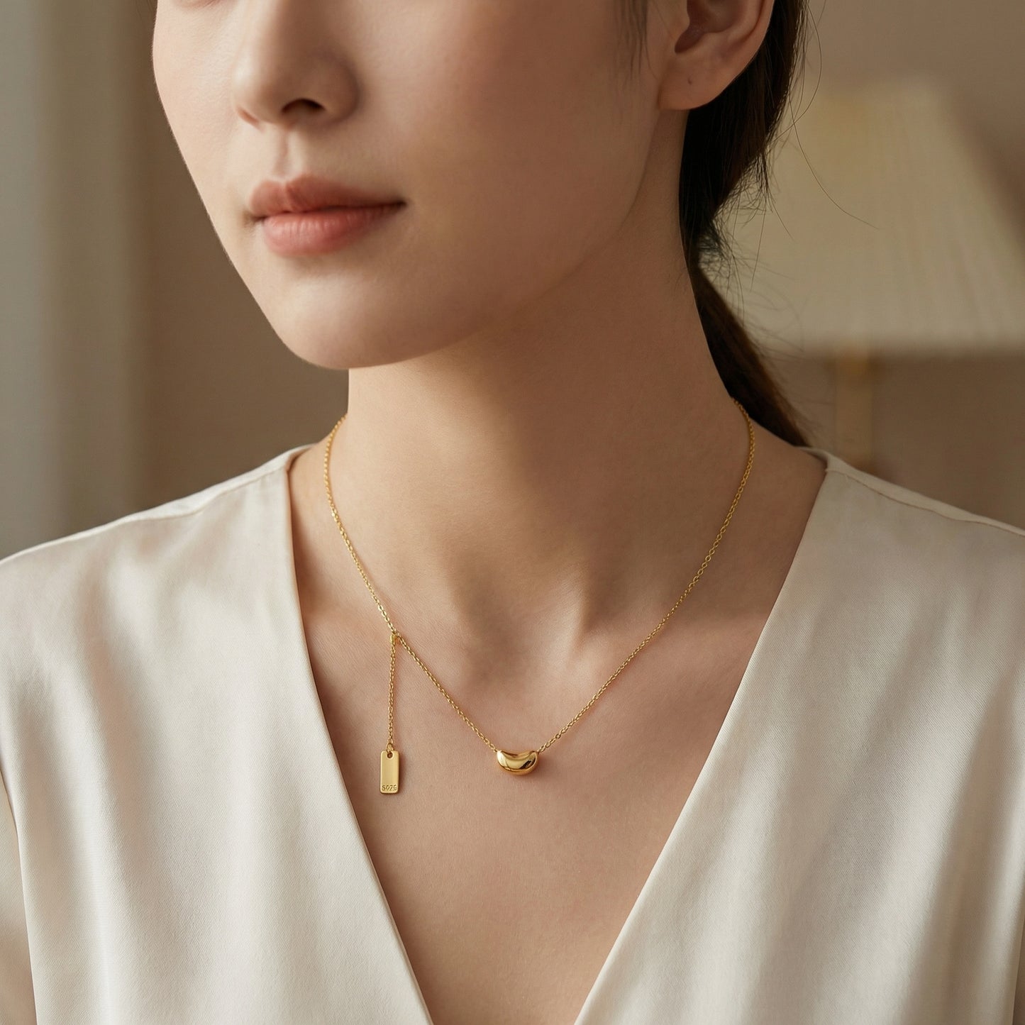 Sterling silver minimalist bean pendant necklace with dainty chain and S925 hallmark tag, crafted by Everyday Auraa.