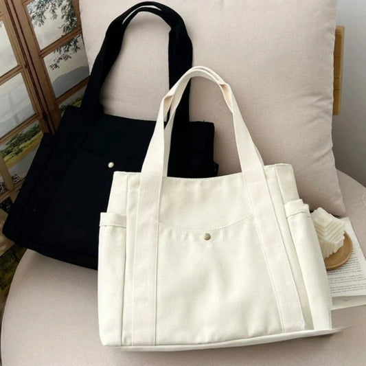 Large capacity canvas tote bag by Everyday Auraa with shoulder straps, ideal for work, college, shopping, and carrying laptops.