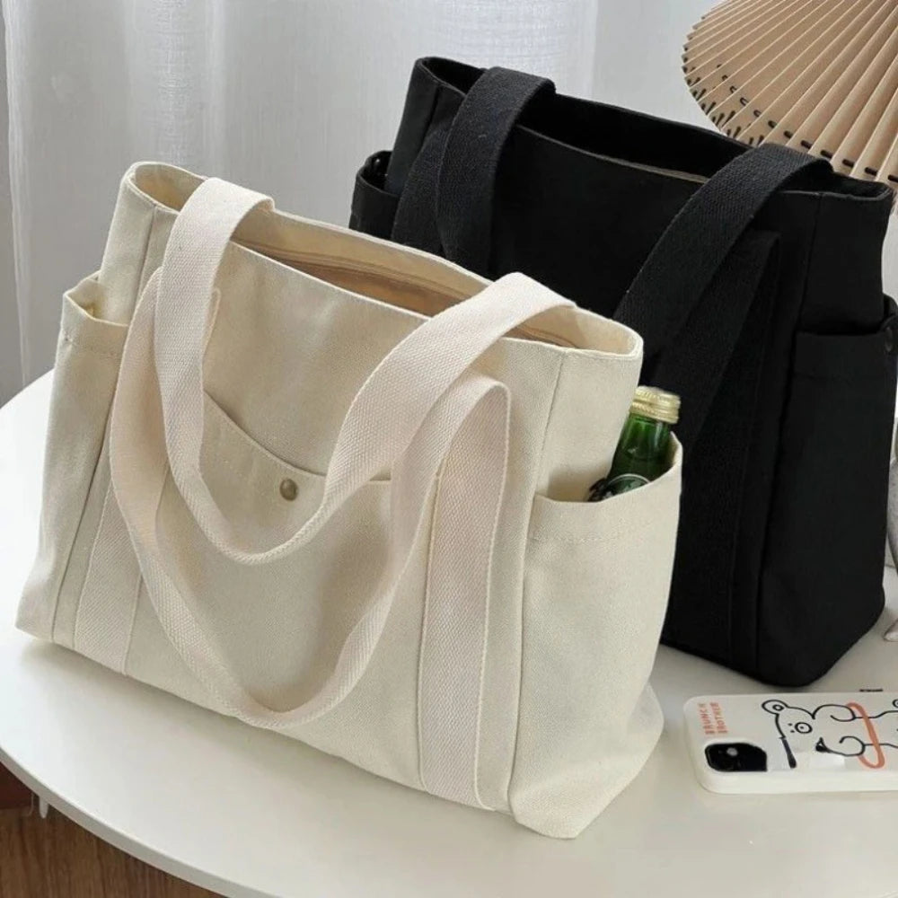 Large capacity canvas tote bag by Everyday Auraa with shoulder straps, ideal for work, college, shopping, and carrying laptops.
