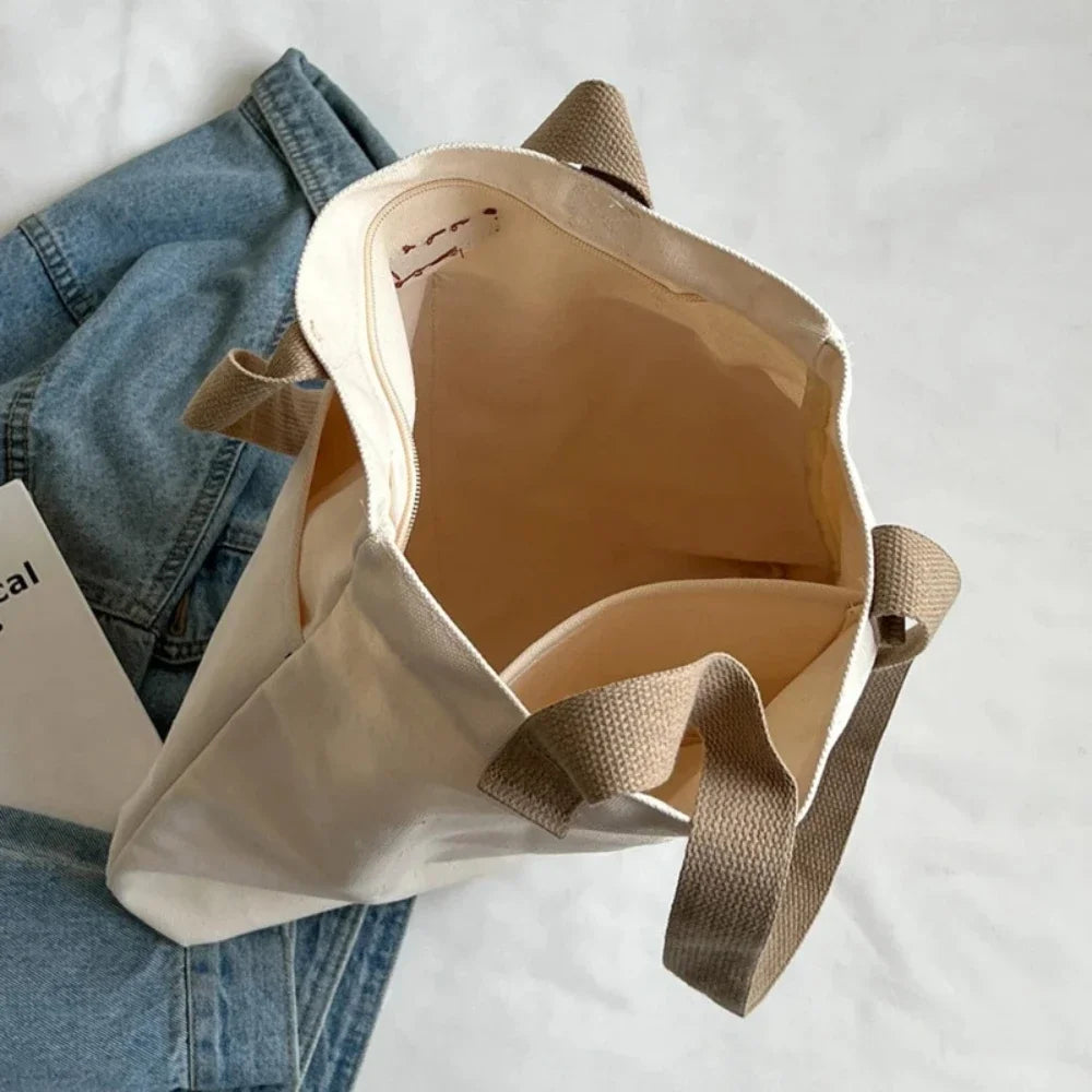 Large capacity canvas tote bag by Everyday Auraa with casual shoulder design, perfect for shopping, commuting, and everyday carry.