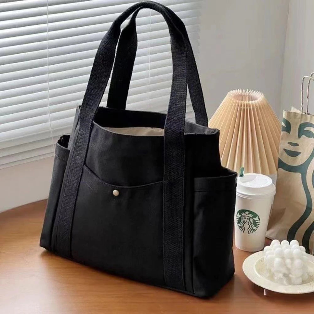 Large capacity canvas tote bag by Everyday Auraa with shoulder straps, ideal for work, college, shopping, and carrying laptops.