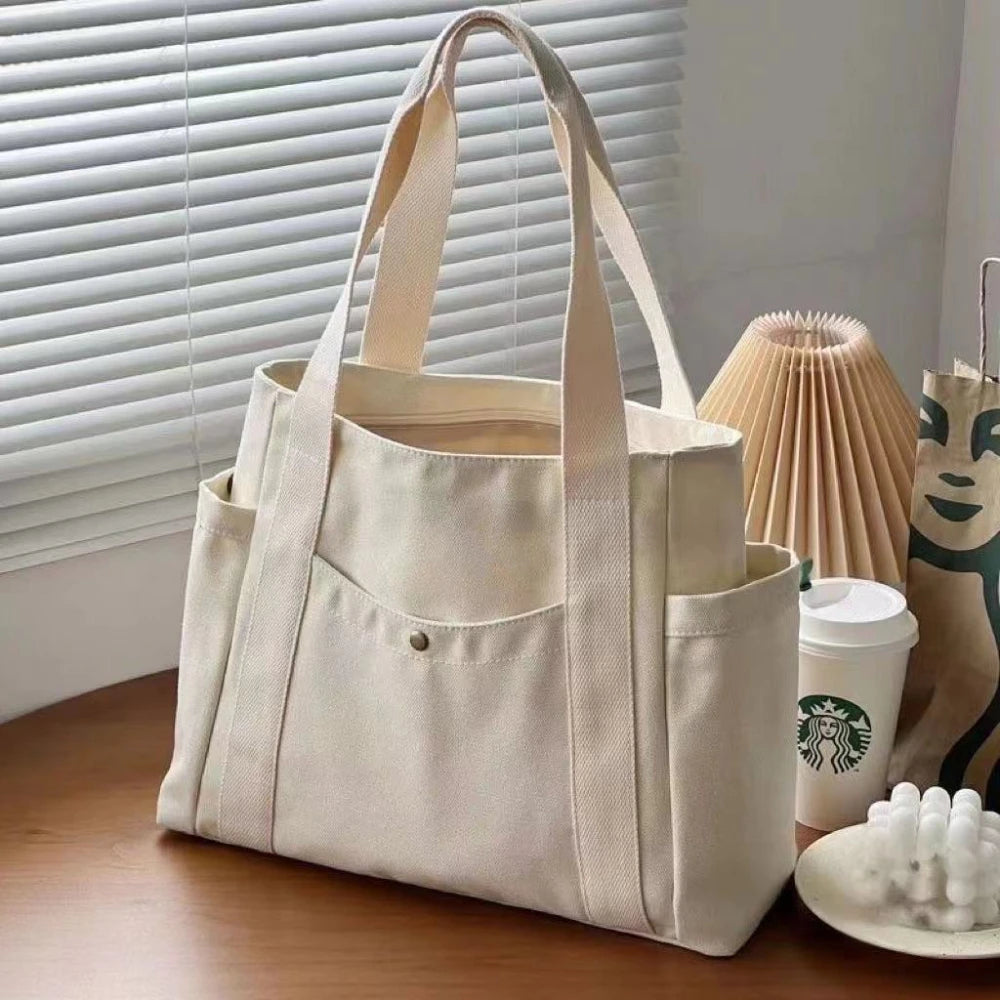 Large capacity canvas tote bag by Everyday Auraa, ideal for work, college, shopping, and carrying laptops or essentials.